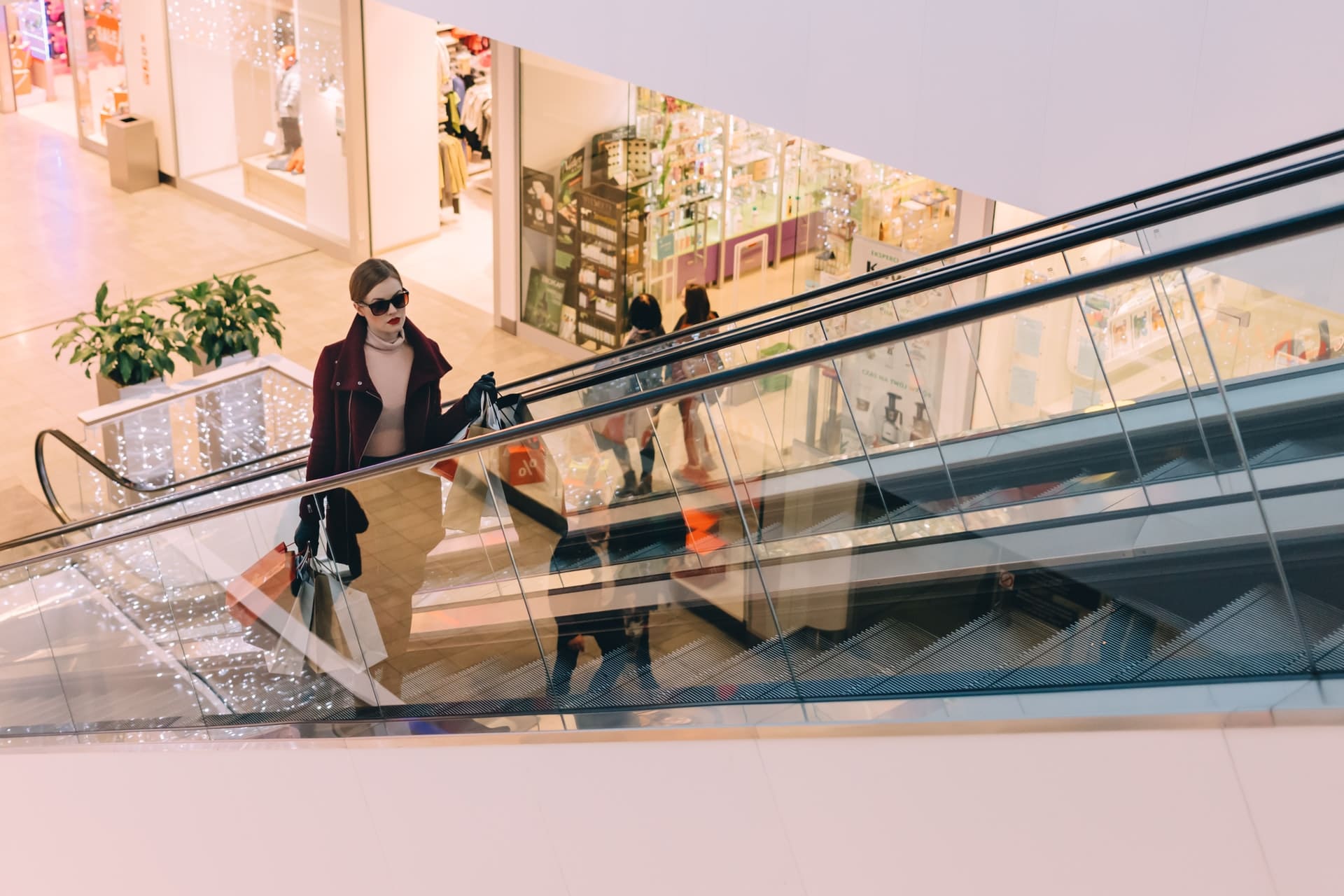 Eine Frau auf der Rolltreppe eines Einkaufzentrums repräsentiert eine der 10 Consumer Styles von MBI.