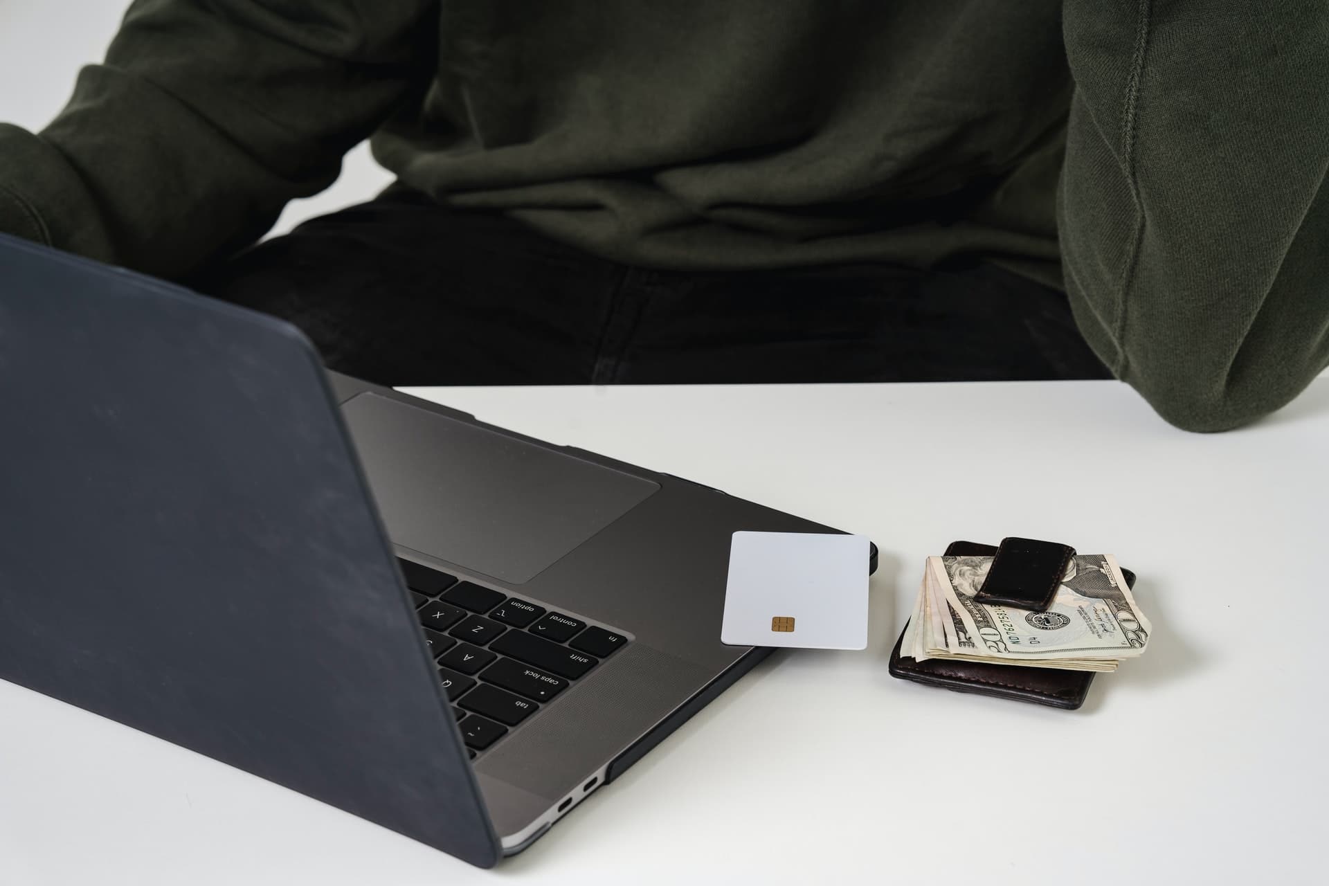 Laptop, credit card and banknotes as an exemplary representation for online purchasing power for Germany