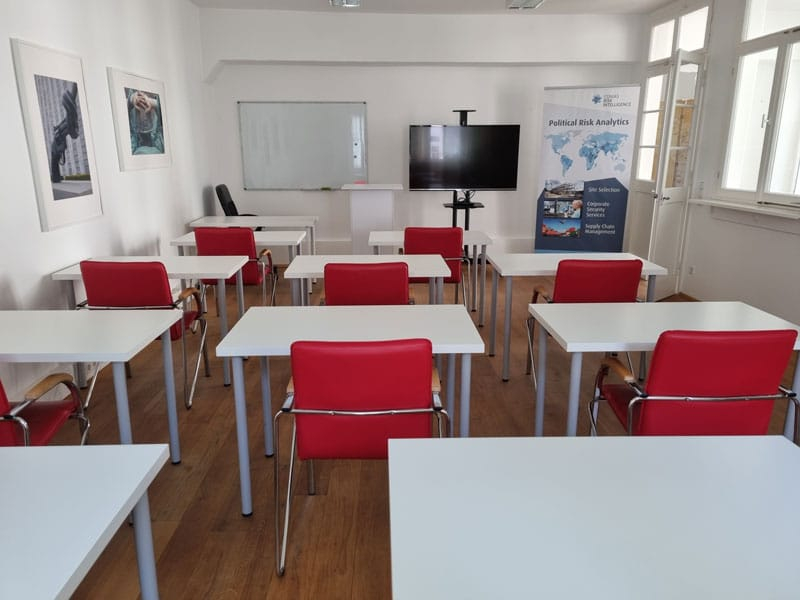 Ein Seminarraum der CONIAS Academy. Auf der Tafel werden politische Risiken erklärt.