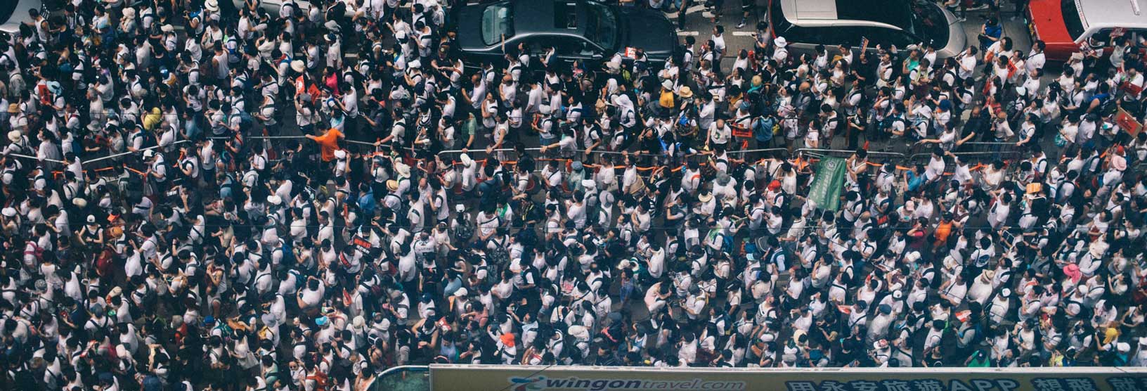 A crowd on the street seen from above symbolizes MBI's population data.