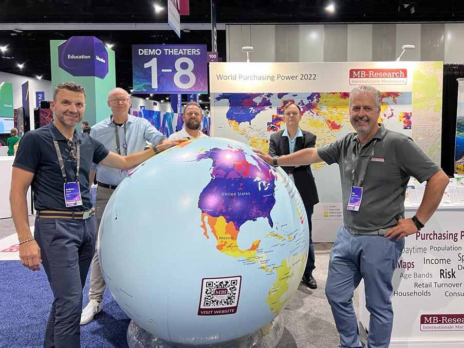 The MBI eam and MBR Team at Esri UC. Ray and Andreas are standing next to the globe on which our globally consistent and comparable geodata are shown.